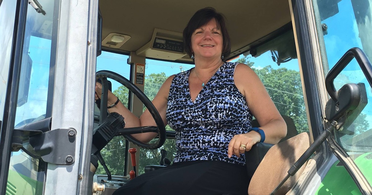 Michelle Rodgers sitting on a green tractor