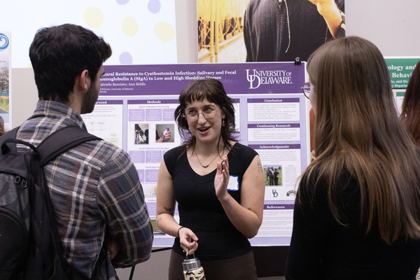 Pre-veterinary medicine major Gianna Metzger explains her research poster.