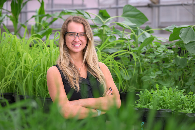 Statistics student Audrey Bufano stands in a greenhouse at FMC, a global agricultural sciences company, where she can apply all of her statistics skills.