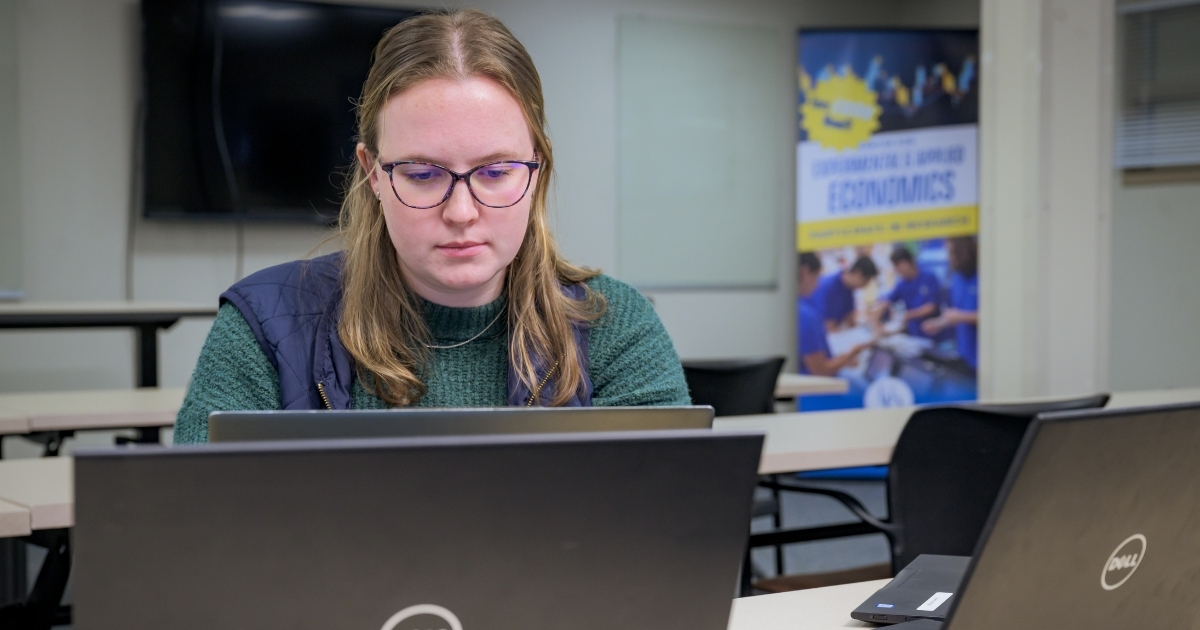 Graduate student Laura Taylor works on her laptop.