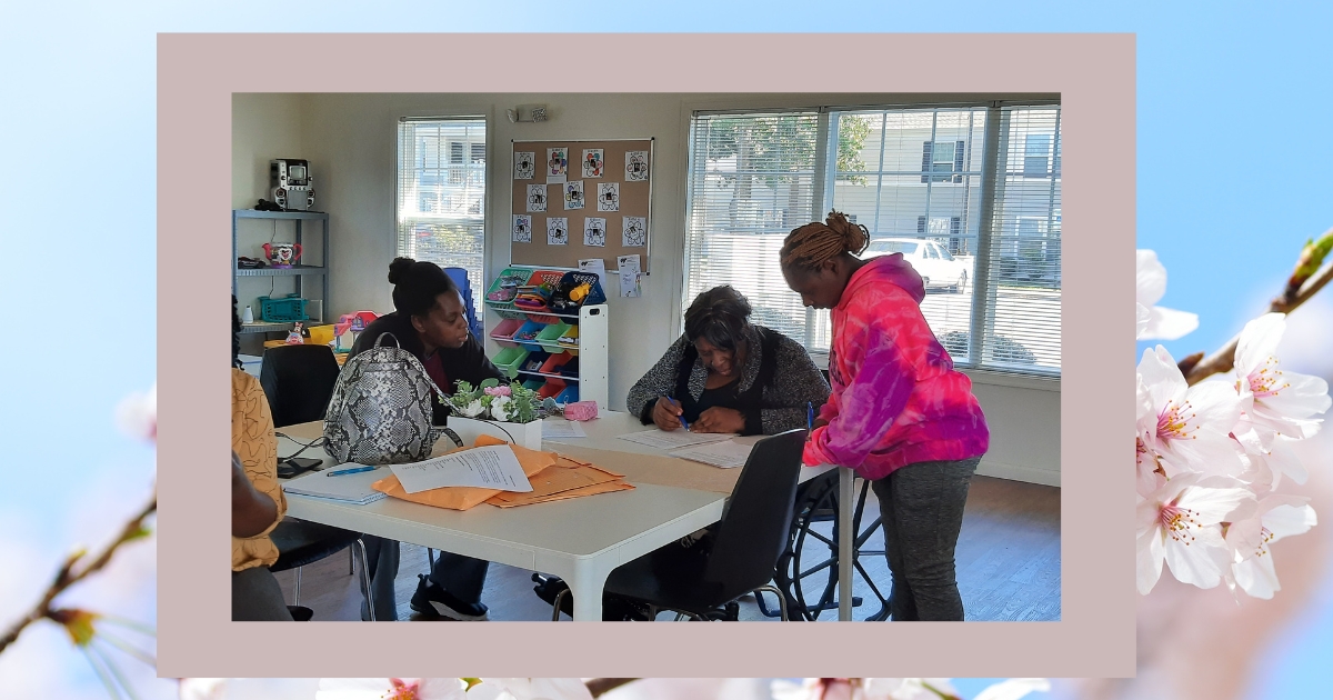 Volunteers around a table working on a project