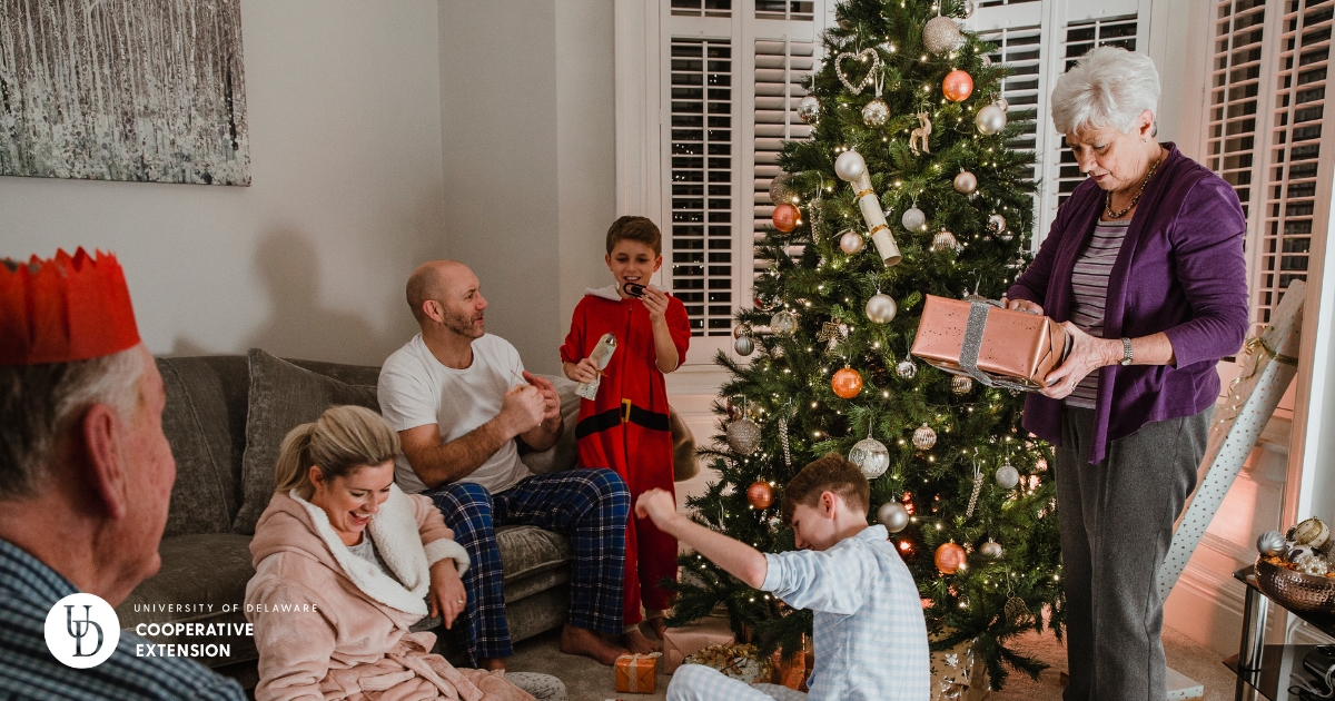 A family opening presents near the Christmas tree A family opening presents near the Christmas tree