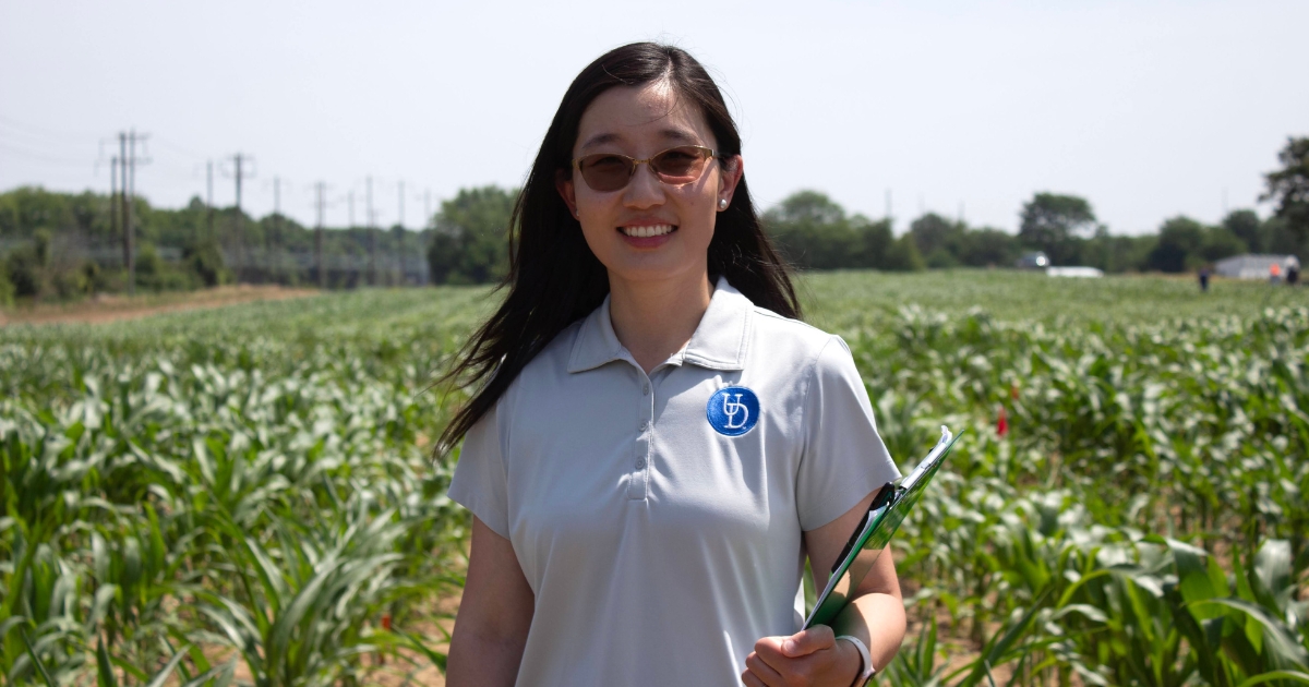 qi_mu_website_properties_img_canr_1200x630 - 1 Qi Mu standing in a test field on the UD Farm in Newark.