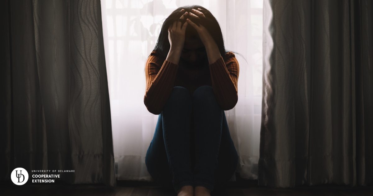 drug22 - 1 A woman in a dark room with her hands on her head in distress