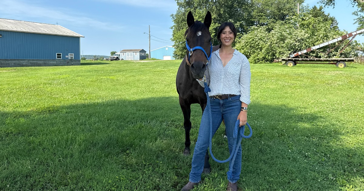 Alexa Johnson stands with a horse.