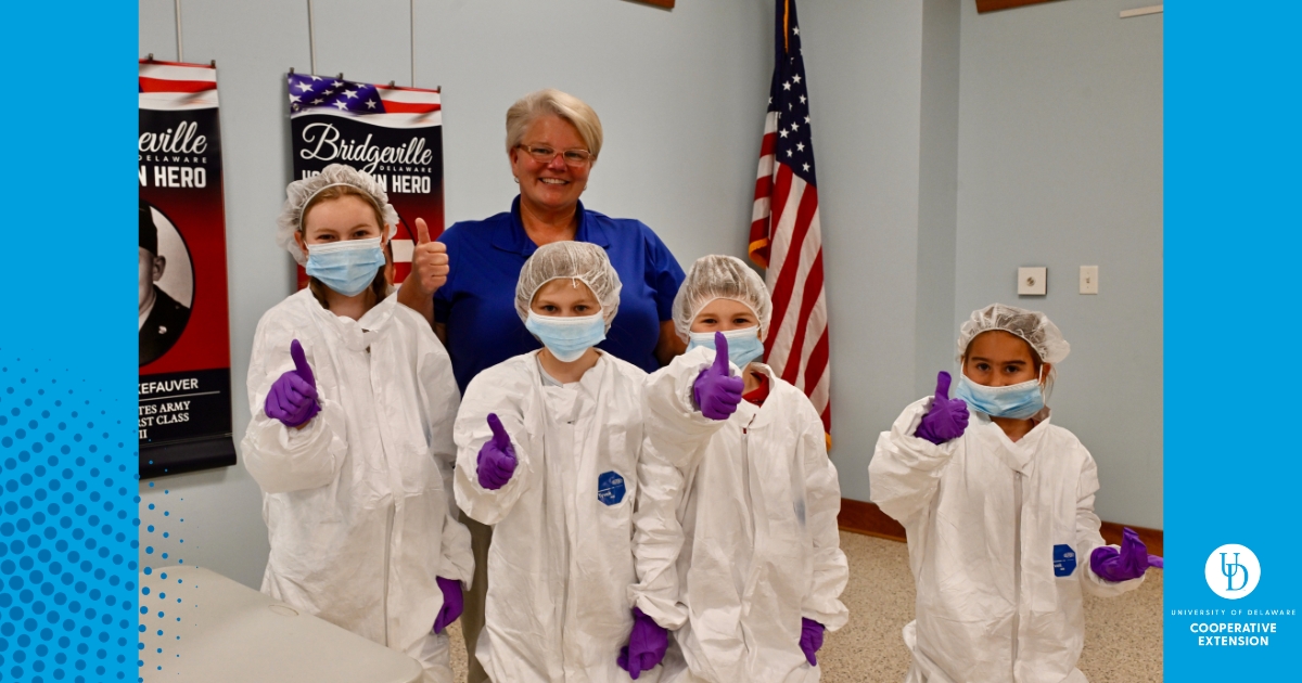 Georgie Cartanza with children in PPE gear
