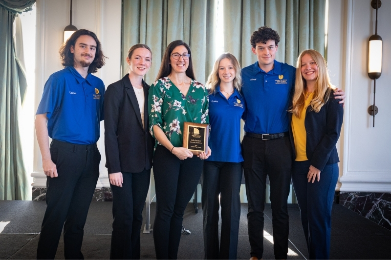 Kelly Davidson and the NAMA team pose with Davidson's award.