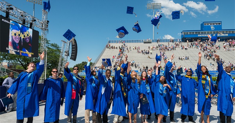 Students in graduation cap and gown at ceremony