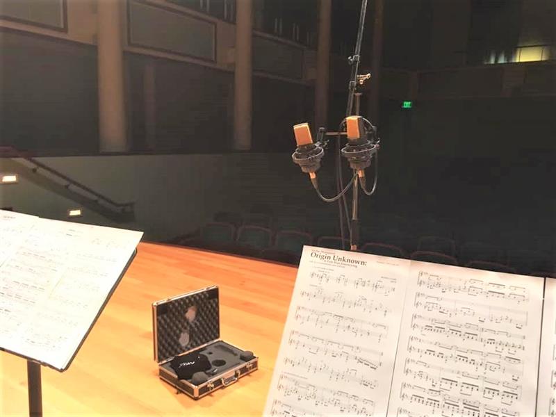 On stage with microphones and sheet music On stage with microphones and sheet music
