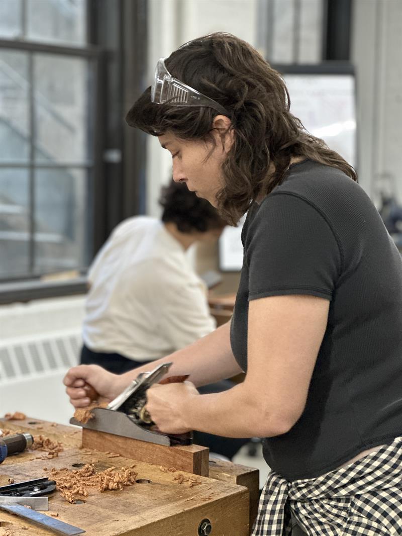 A student works with a hand plane during class. A student works with a hand plane during class.