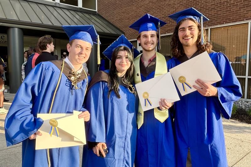 UD AAP Graduates standing with certififcates after convocation