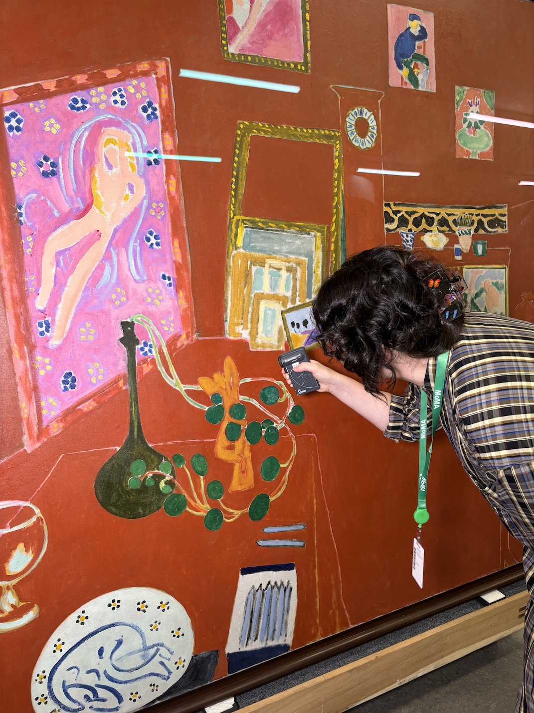WUDPAC Class of 2025 Fellow Emily Landry examines The Red Studio by Henri Matisse. student examining art on wall
