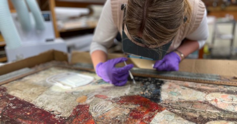 UD Class of 2027 art conservation major Madison Griffin using a syringe to apply adhesive to lifting paint. UD Class of 2027 art conservation major Madison Griffin using a syringe to apply adhesive to lifting paint.