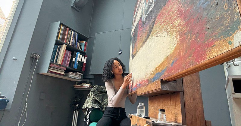 Student painting on canvas