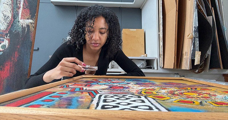 Student examining art piece