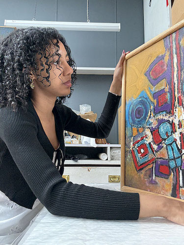 student examining art piece