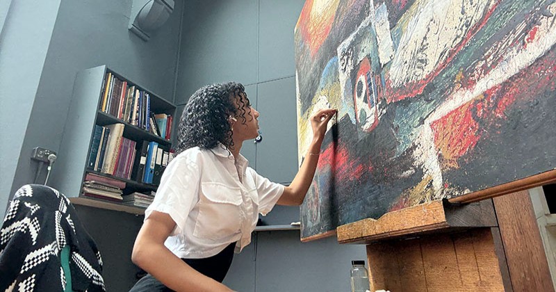 Student painting on canvas