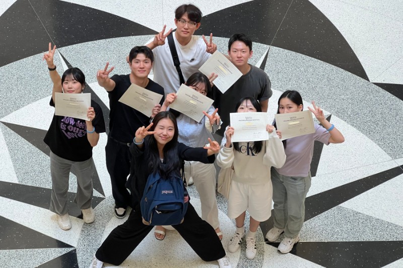 students holding papers students holding papers and putting peace sign up
