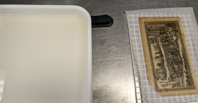 A print with bath solution next to it A print with bath solution next to it