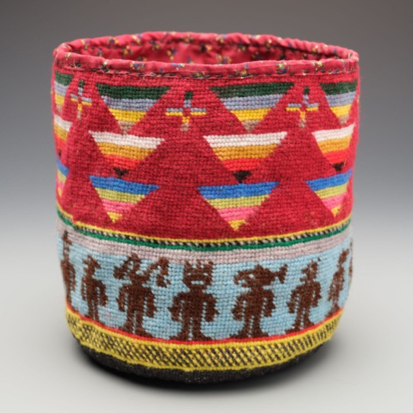 Colorful textile art piece in red, blue, brown and yellow.
