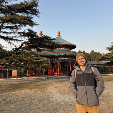 A college student standing in front of the Temple of Heaven in Beijing, China.