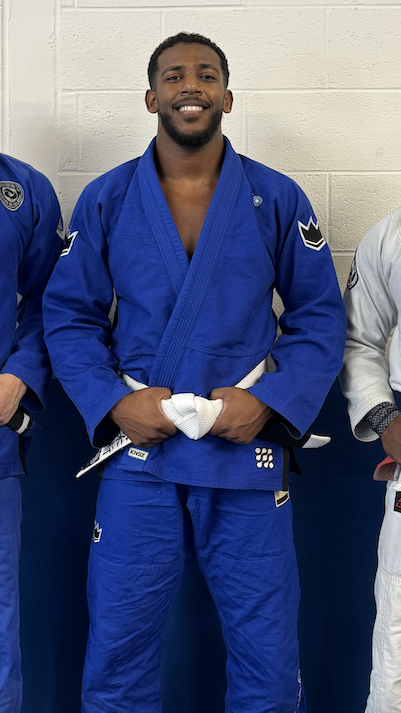 Alharbi poses and smiles in jiu-jitsu outfits.