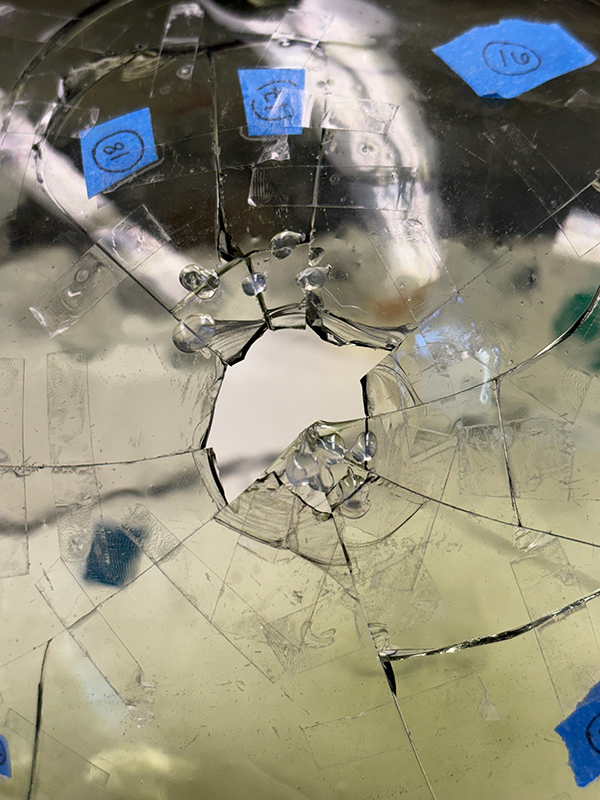 A close-up view of a broken green glass jug.