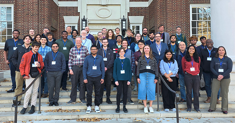 A group of 45 mathematicians gathered on the front steps of a historic academic building on the University of Delaware campus.