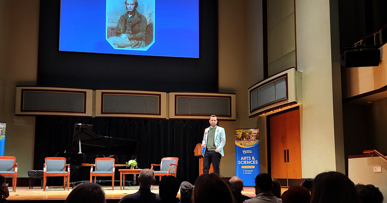 Dean Caleb Everett delivering his presentation on human evolution