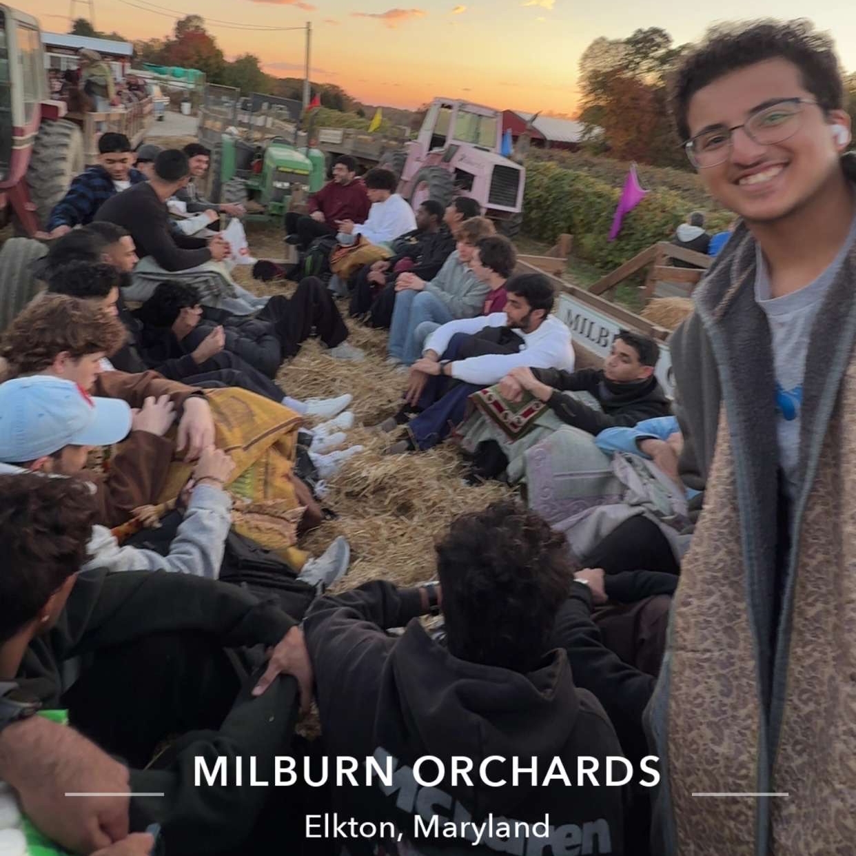 Salem smiles on a hayride with friends. Text in the photo says MIlburn Orchards, Elkton, Maryland.