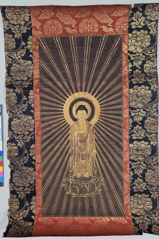 Image of the Amida painting before remounting, showing red and blue temple-style mounting fabrics.