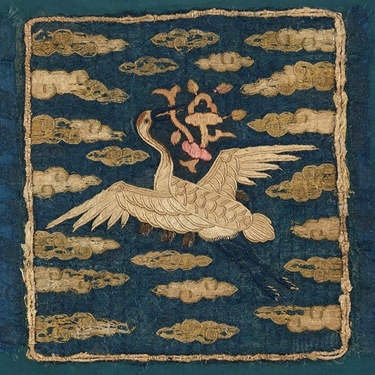 19th century textile with embroidered crane flying through puffy clouds on dark blue background.