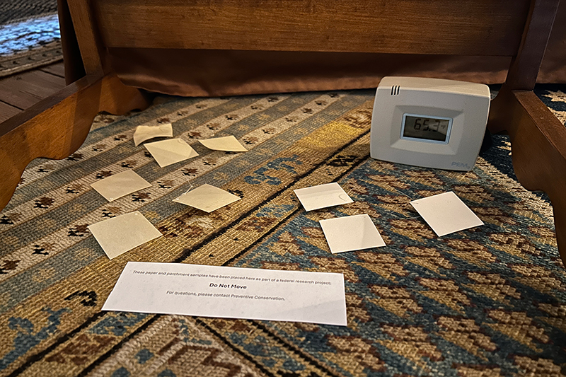 A meter and small slips of paper on top of a bed.