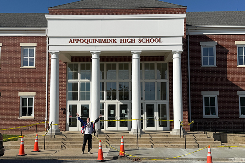 A teacher standing in front of Appoquinimink High School