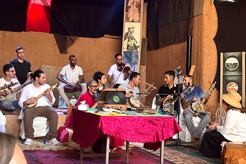A group of musicians performing inside a room.