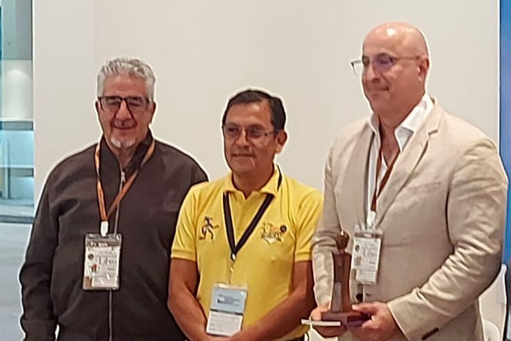 Three smiling people wearing lanyards.