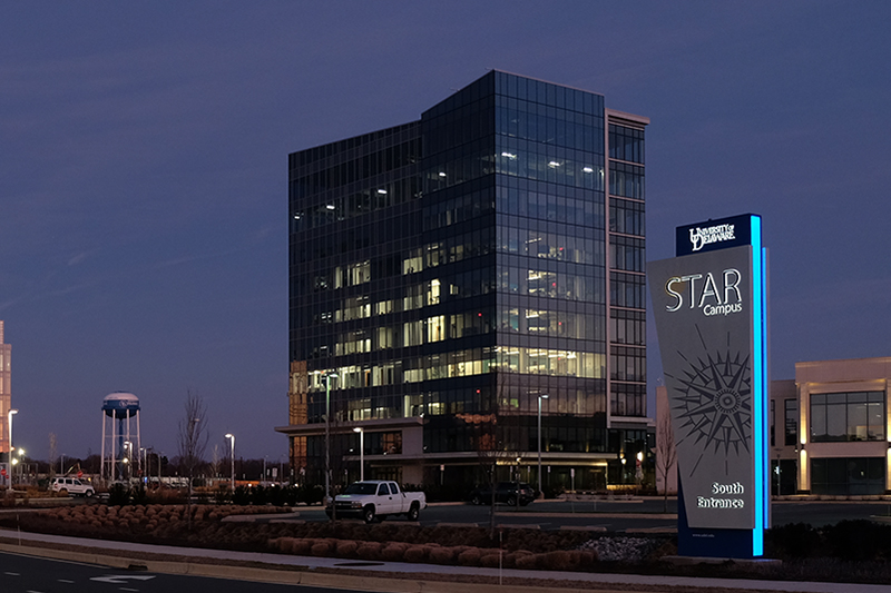 STAR Tower, a six-story, contemporary glass building, on the University of Delaware STAR Campus, at sunset.