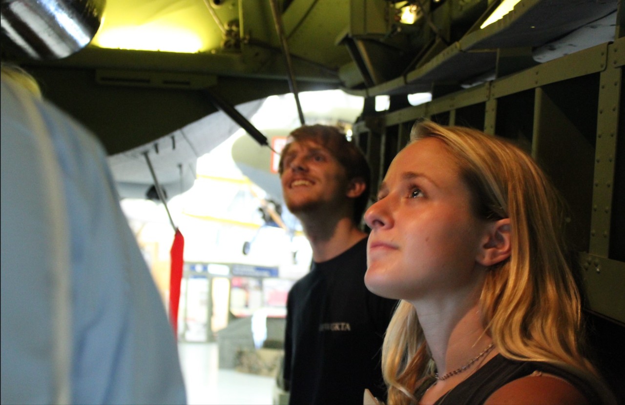 Students look engaged in a museum studies exhibit