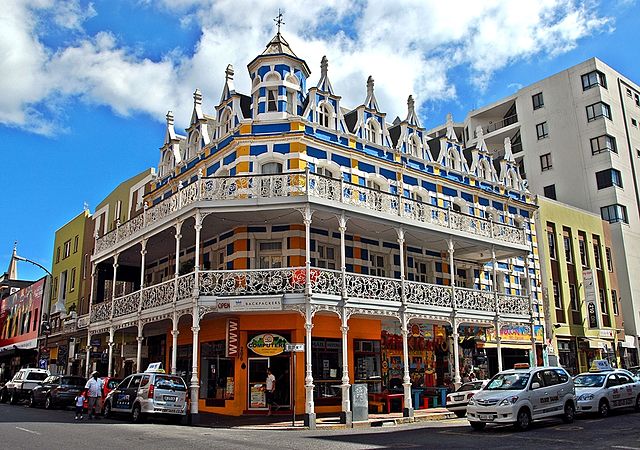 Blue Lodge, an ornate and colorful hotel with two balconies on a city corner in Cape Town, Africa. 