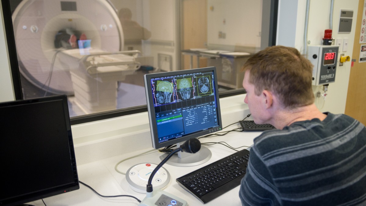 Student working with an MRI machine in class