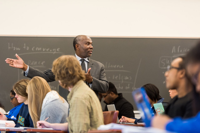 Professor lecturing in classroom students looking engaged