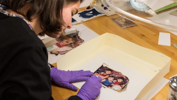 Student restoring family photos burned in a fire