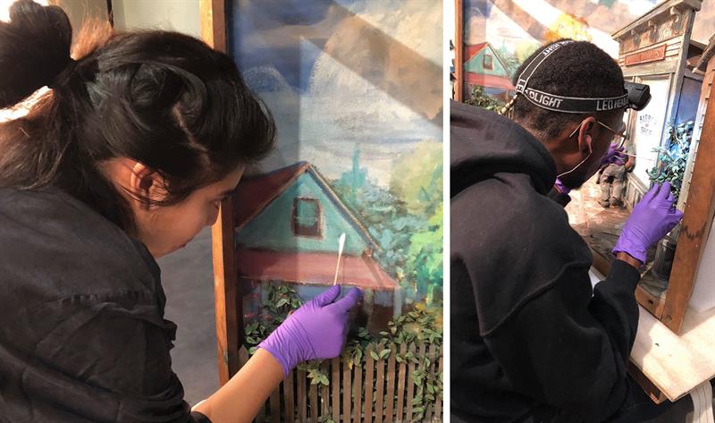 Students working on preserving and cleaning historical paintings and dioramas.