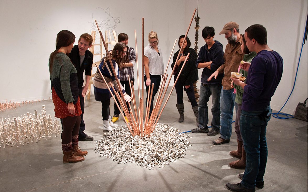 BFA Fine Arts students work on an interactive group art project in class involving craft sticks 
