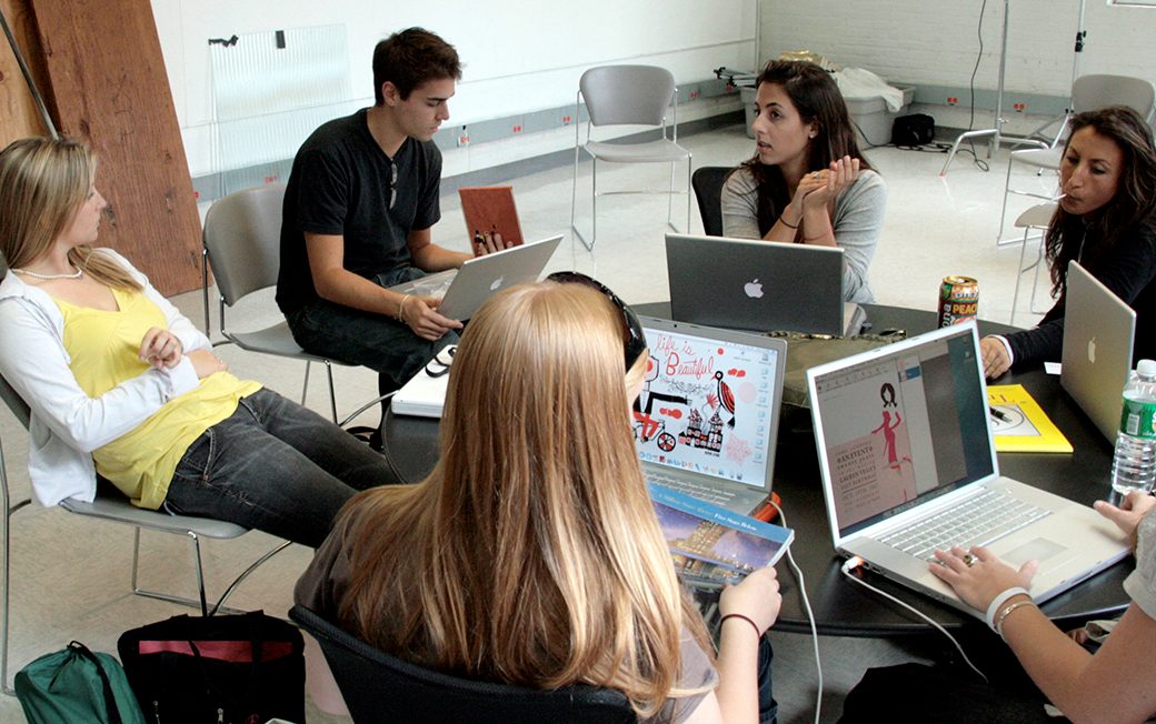 Visual communications students work together in class.