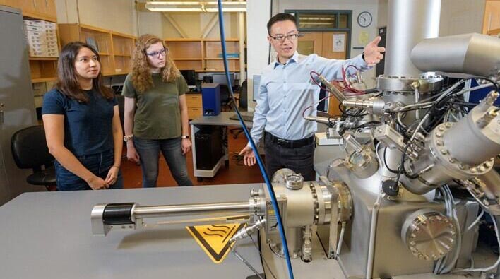 Surface Analysis Facility with studennts and faculty engaging with machinery