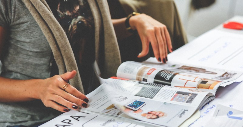 Hands flipping through a magazine