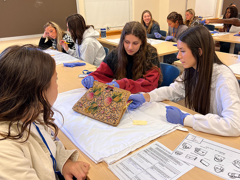 Students looking at fashion design