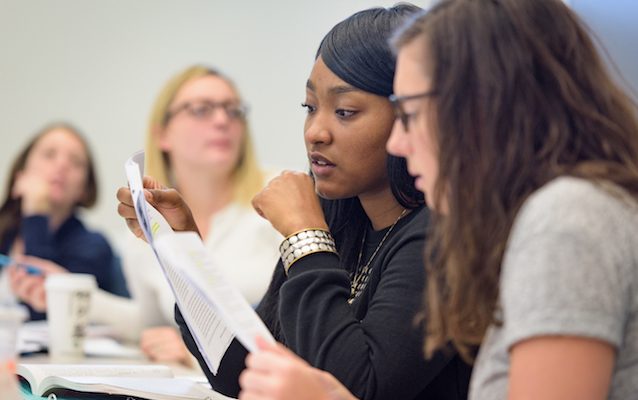 Professor lecturing in classroom students looking engaged
