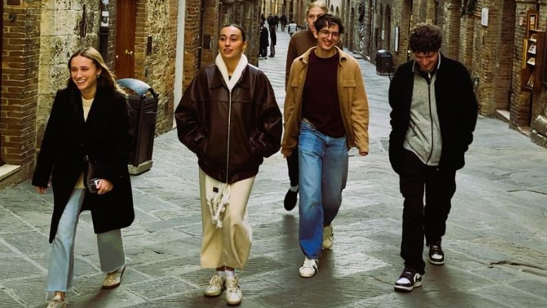Group of five students walking down an alley in Florence Italy